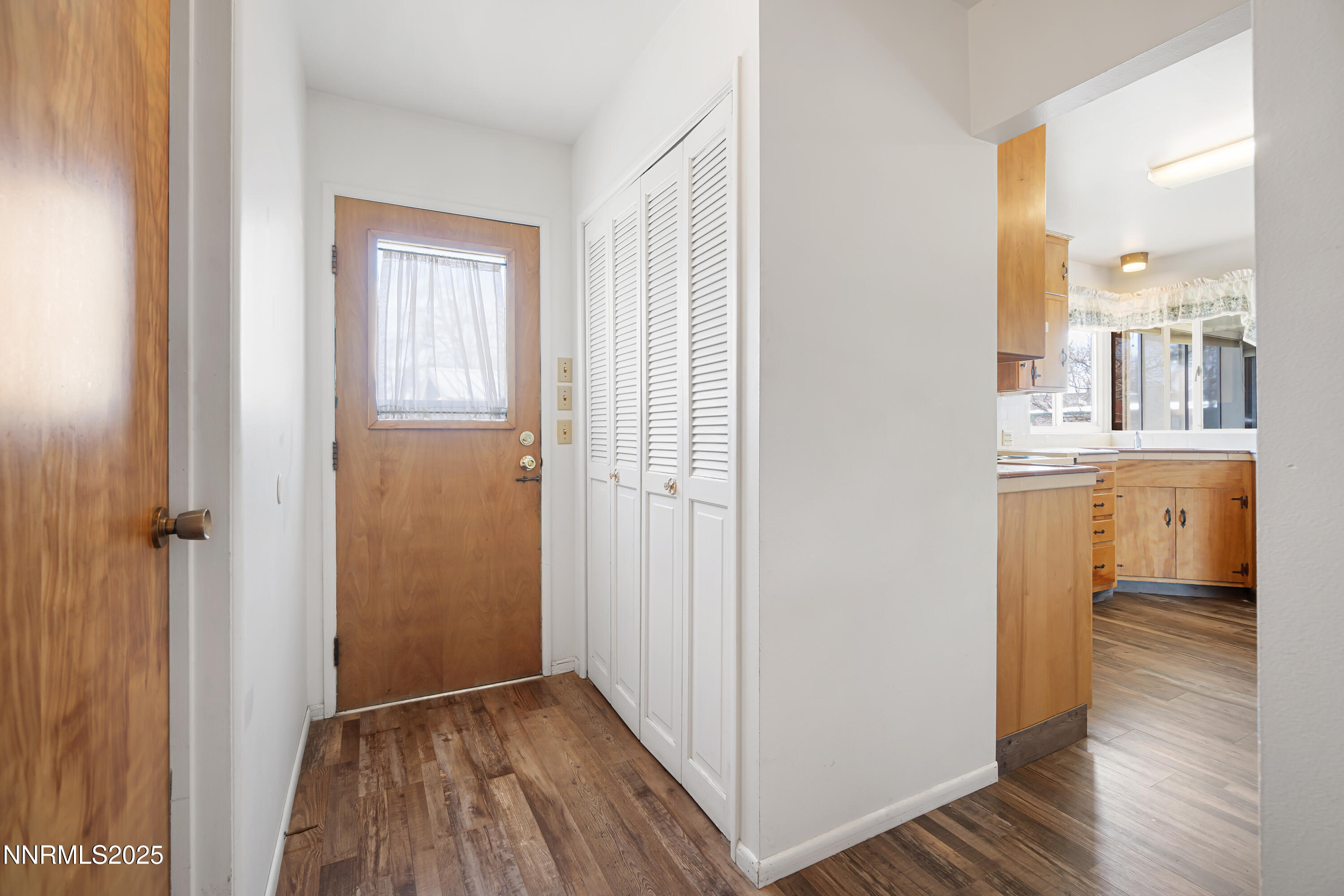 475 South Bailey Street Fallon, NV 89406 - Photo 12 of 27 a view of a kitchen from the hallway with a hardwood floor and a sink