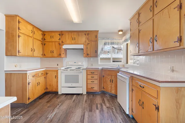 a kitchen with stainless steel appliances white cabinets and a sink