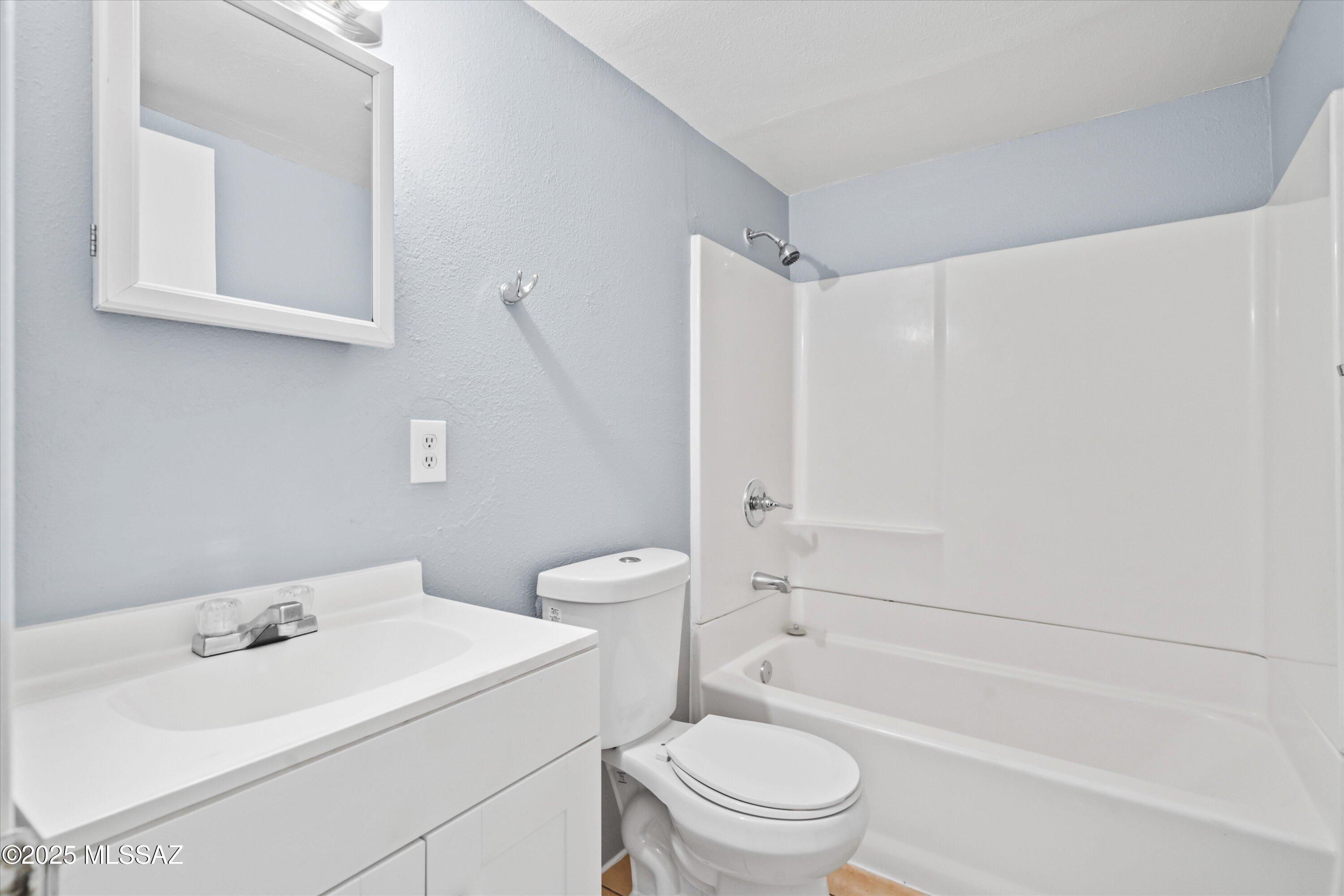 1227 East Ginter Road Tucson, AZ 85706 - Photo 7 of 18 a bathroom with a sink toilet vanity and shower
