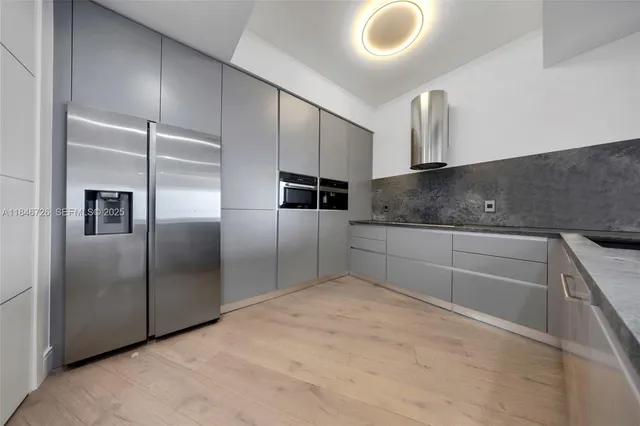 a kitchen with granite countertop a sink and a stove top oven