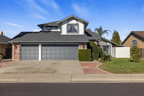 a front view of a house with a yard and garage