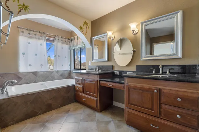 a spacious bathroom with a double vanity sink and a mirror