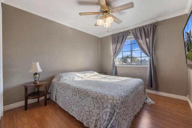 a bedroom with a bed and a lamp on the dresser