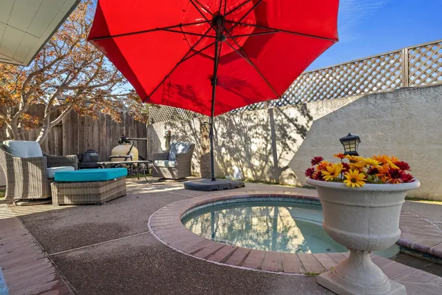 a view of a swimming pool with an outdoor space and seating area