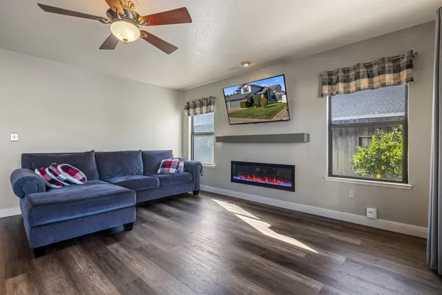 a dining room with furniture a chandelier and wooden floor