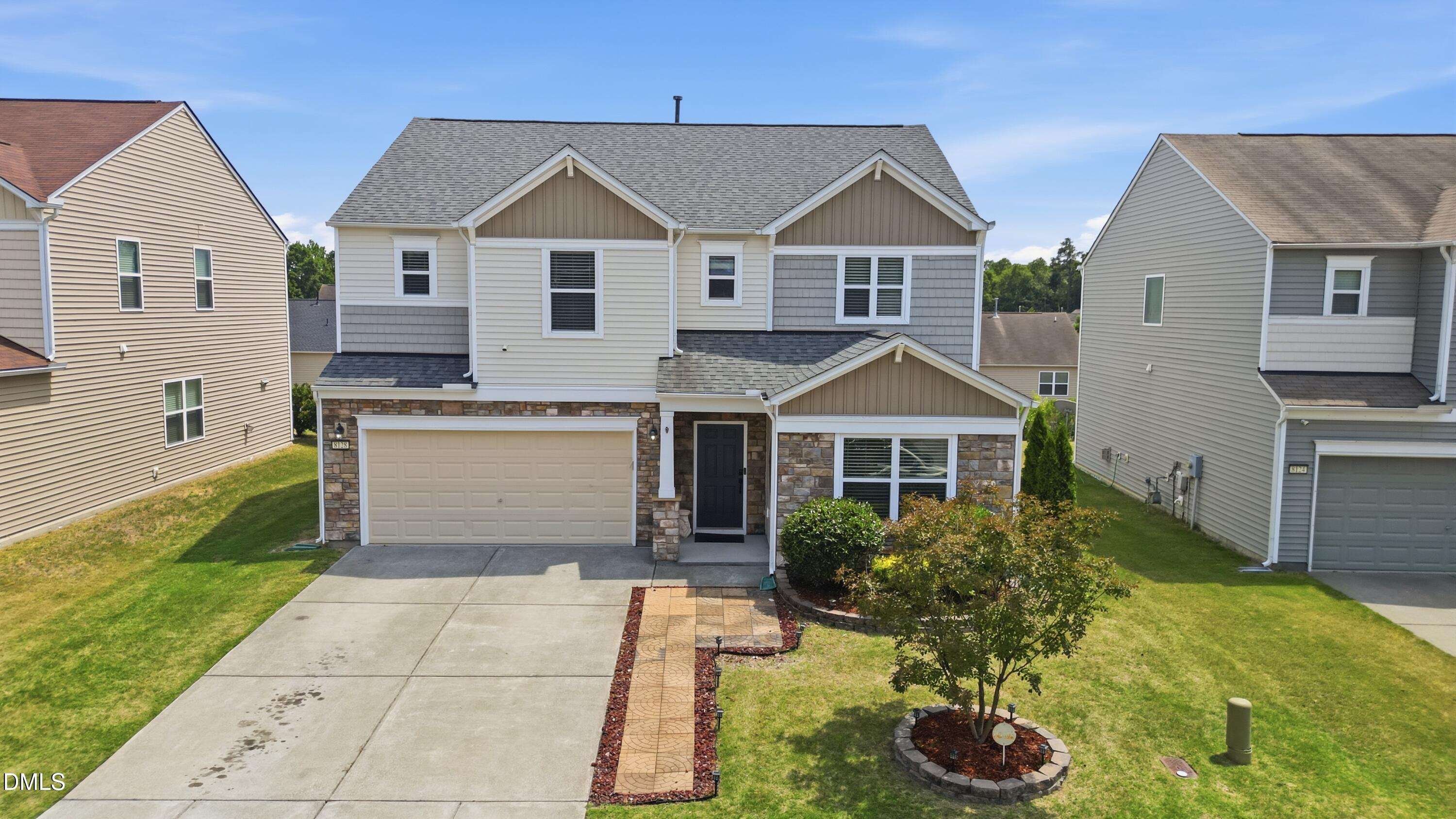 8128 Hovingham Way Raleigh, NC 27616 - Photo 1 of 40 a front view of a house with a yard and garage