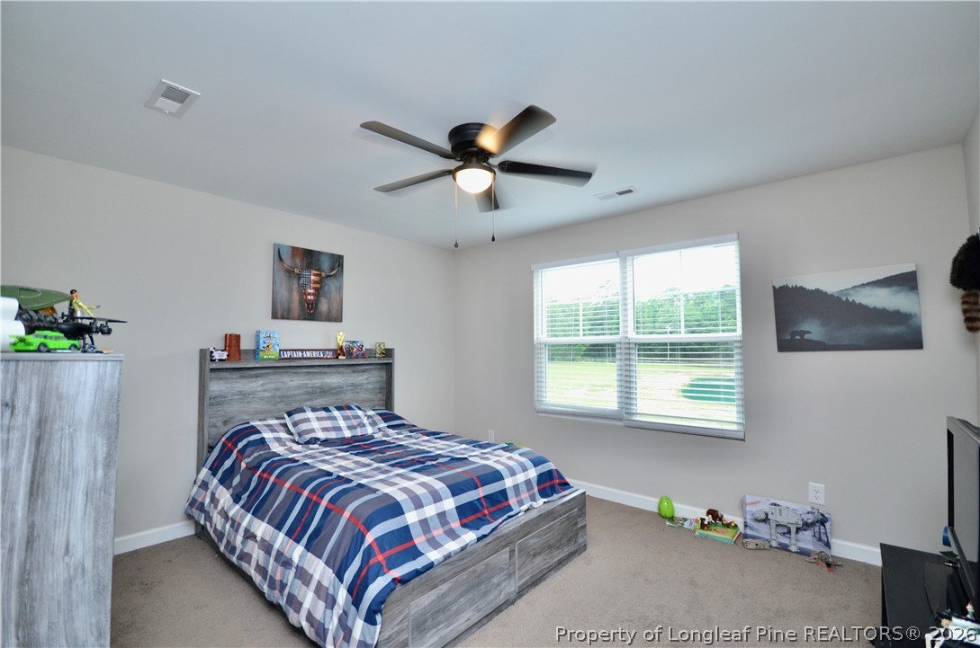1865 John B Carter Road Fayetteville, NC 28312 - Photo 27 of 49 a bedroom with a bed and a window