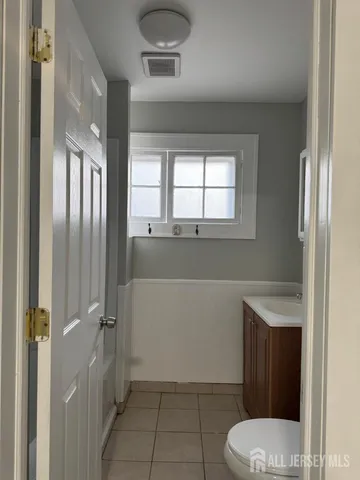 a bathroom with a toilet a sink and window
