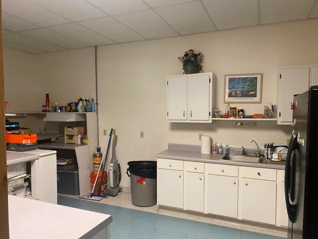 a kitchen with sink a microwave and cabinets