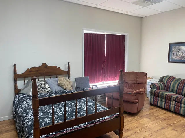 a living room with furniture rug and wooden floor