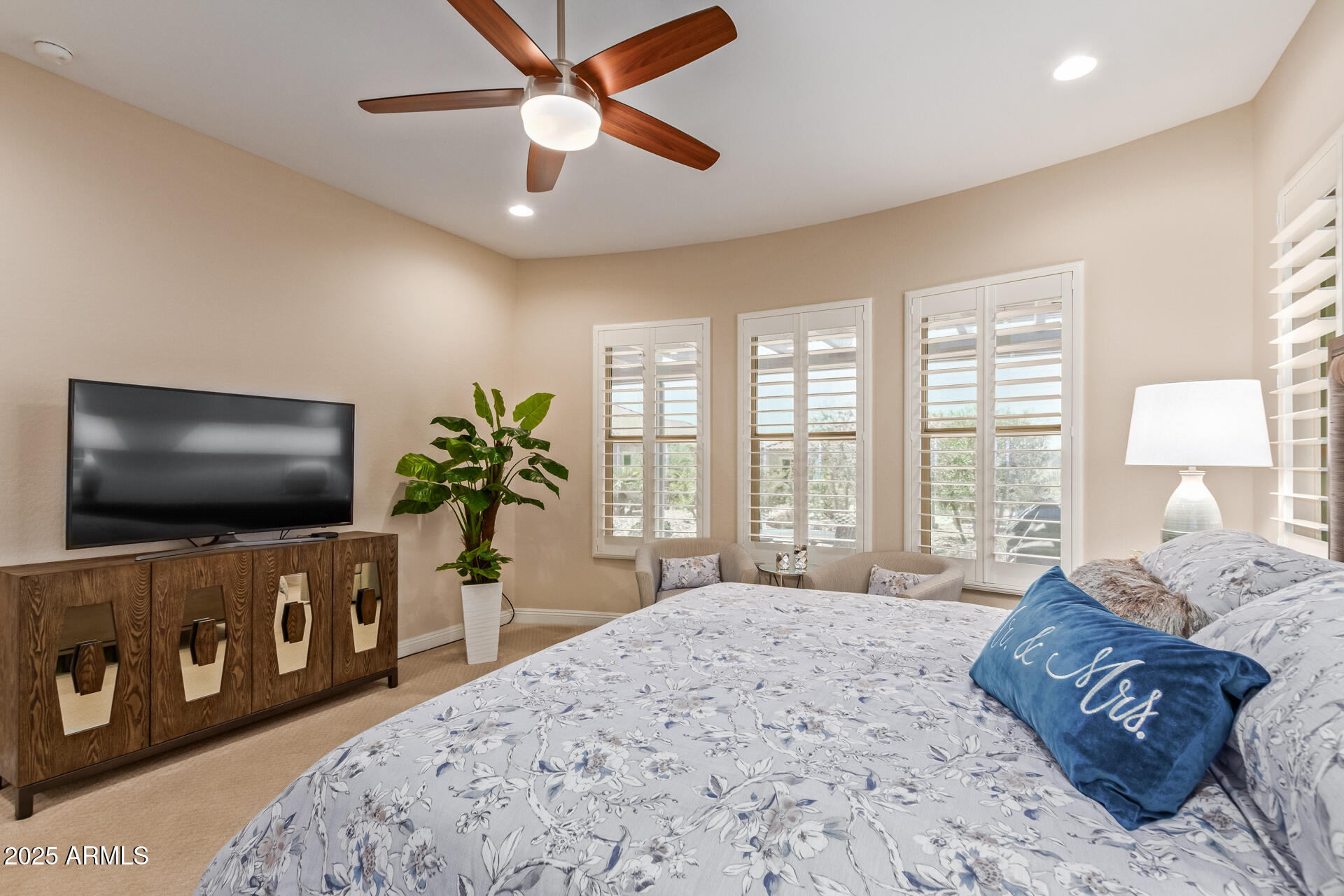 4190 North Imperial Court Florence, AZ 85132 - Photo 38 of 93 a spacious bedroom with a bed and a flat screen tv