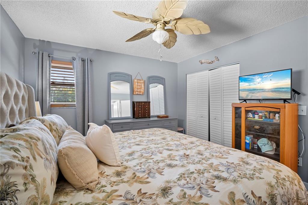 1155 Sandpiper Street, Unit G2 Naples, FL 34102 - Photo 5 of 8 a bedroom with a bed and a large window