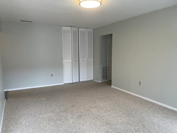 a view of an empty room and a window