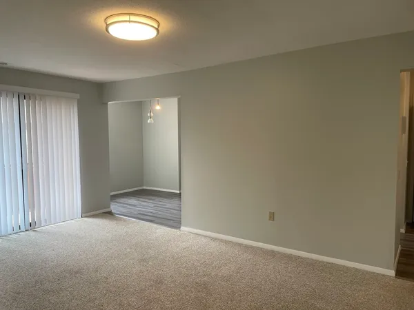 an empty room with a empty space and windows