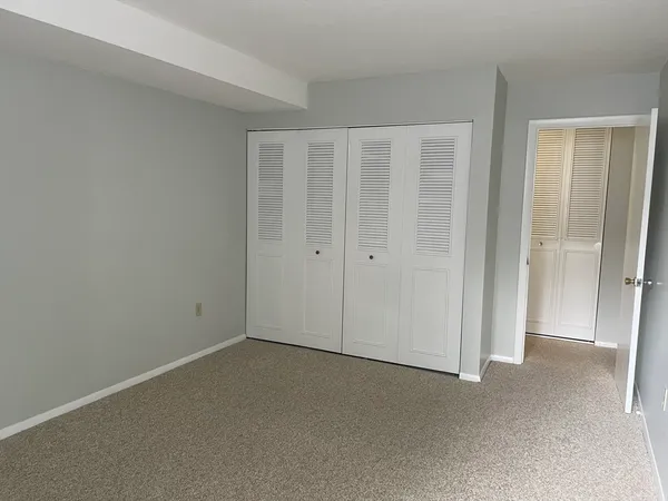 an empty room with closet area