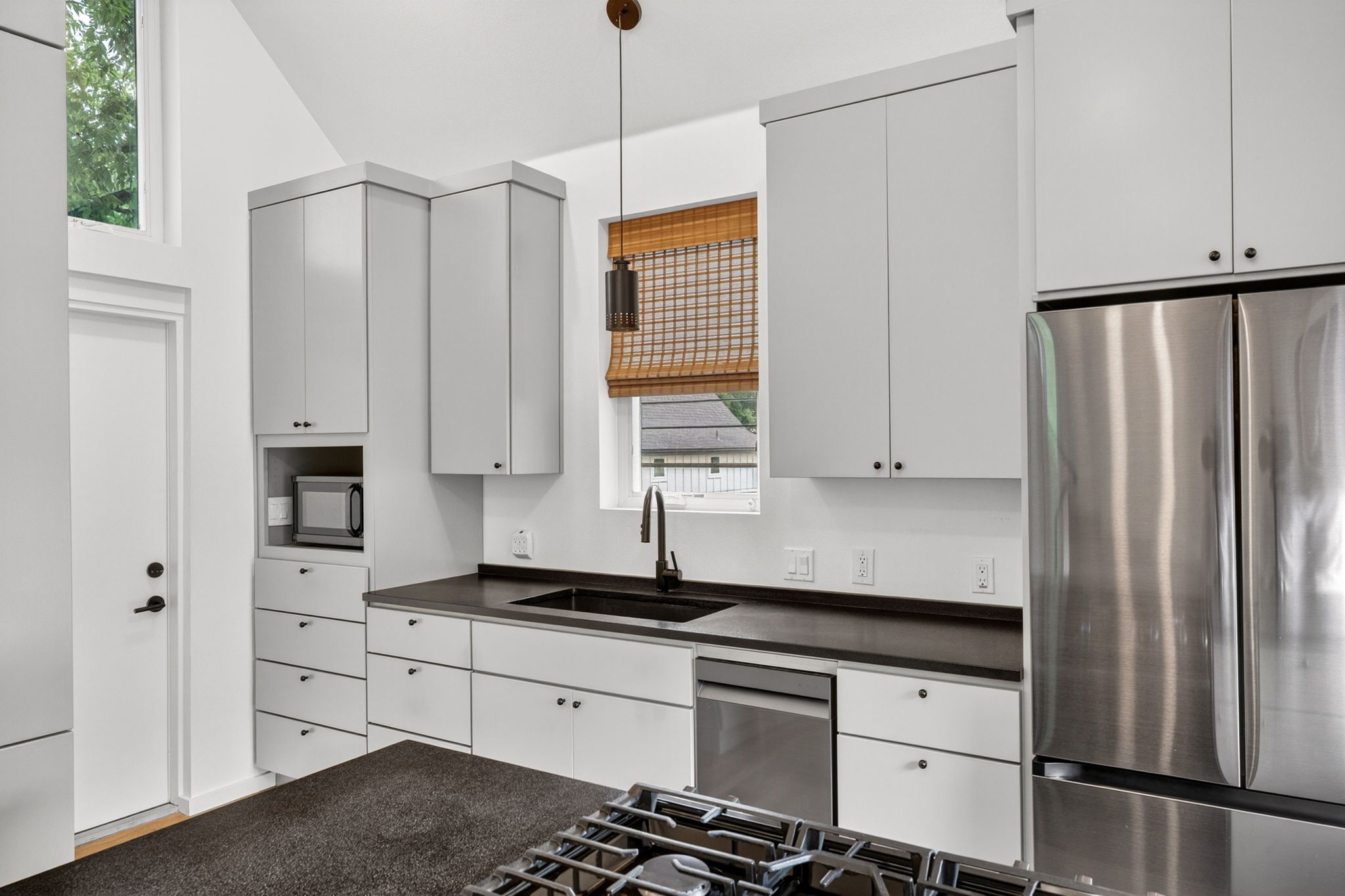 5505 Duval Street, Unit B Austin, TX 78751 - Photo 14 of 32 a kitchen with stainless steel appliances a refrigerator sink and cabinets