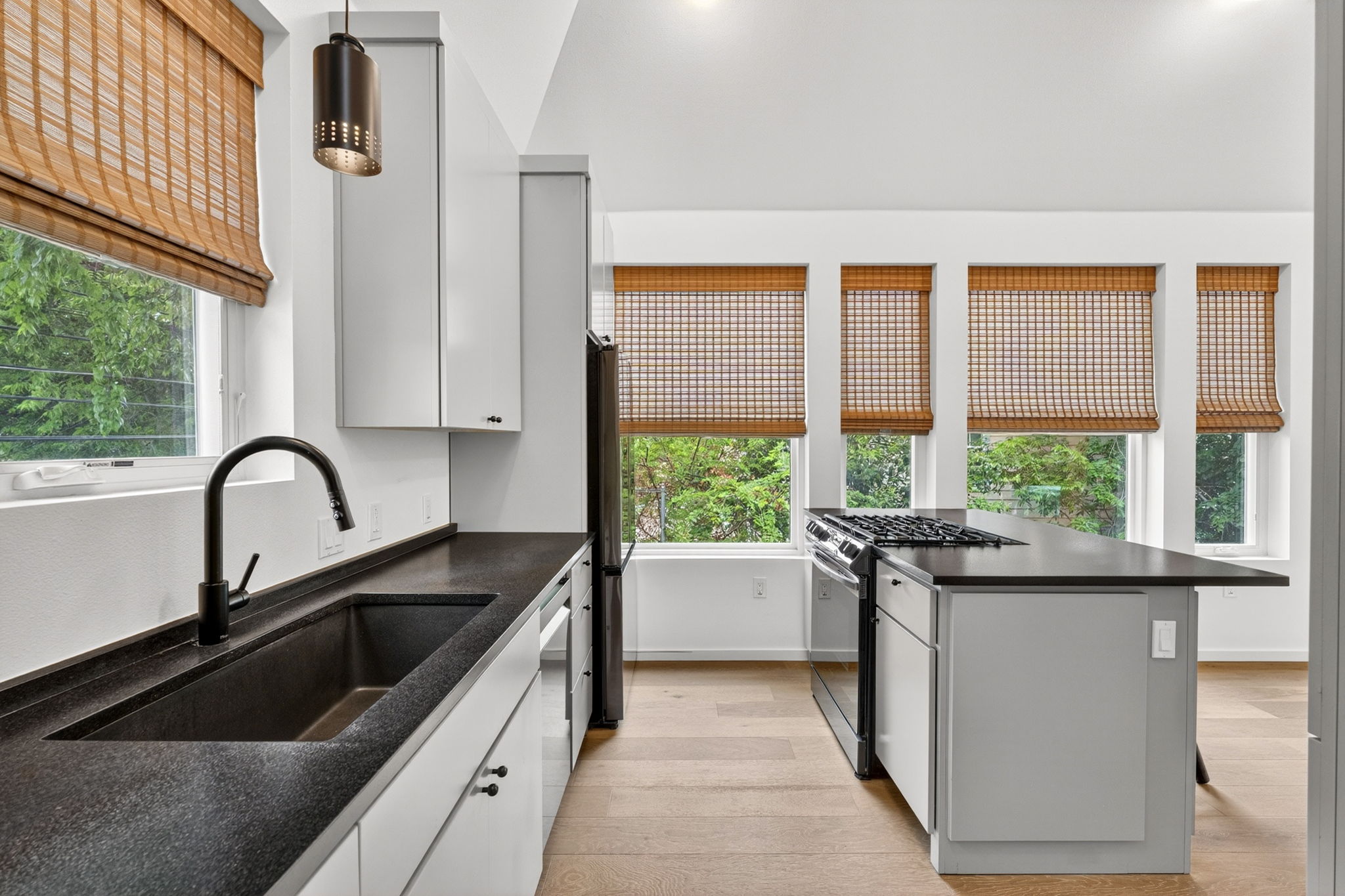 5505 Duval Street, Unit B Austin, TX 78751 - Photo 15 of 32 a kitchen with a sink a counter top space and stainless steel appliances