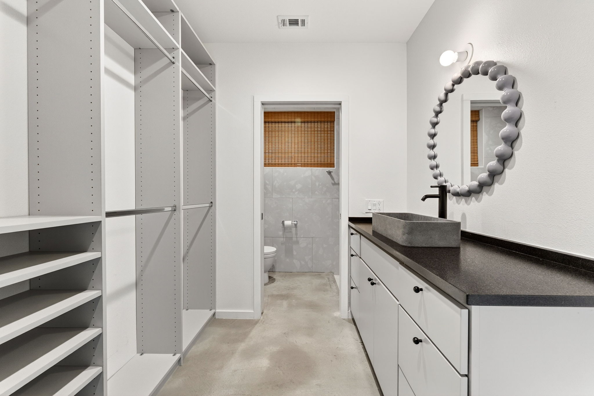 5505 Duval Street, Unit B Austin, TX 78751 - Photo 7 of 32 a spacious bathroom with a granite countertop sink a toilet and a mirror