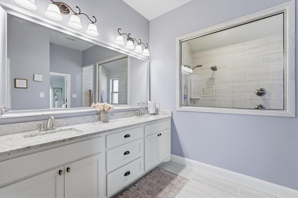 813 Mildren Lane Fate, TX 75087 - Photo 12 of 32 The primary bath offers granite countertops, dual sinks and lots of storage!