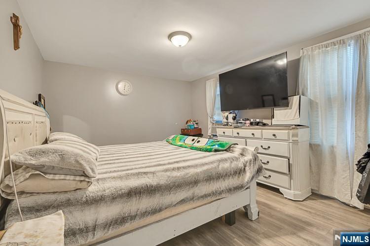 321 Grove Street Bloomfield, NJ 07017 - Photo 13 of 22 a bedroom with a bed and flat screen tv