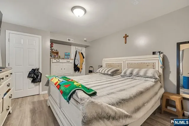 a bedroom with a bed and a dresser