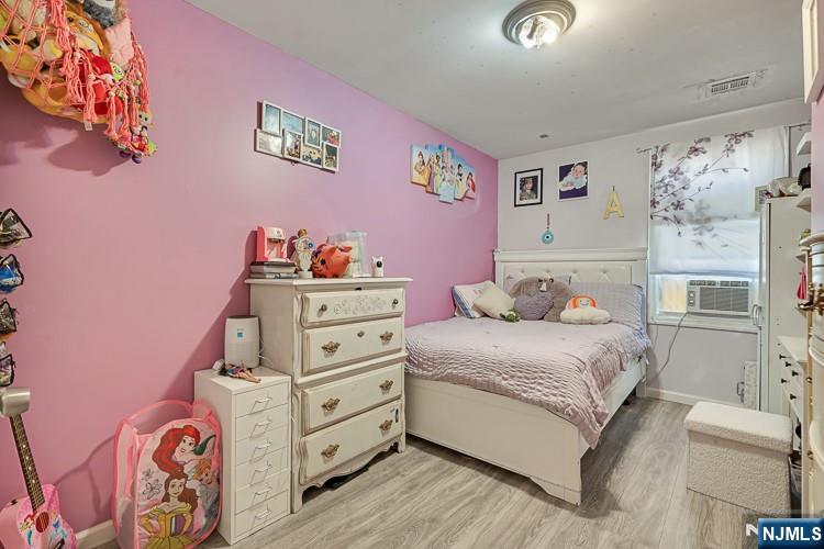 321 Grove Street Bloomfield, NJ 07017 - Photo 15 of 22 a bedroom with a bed and a dresser