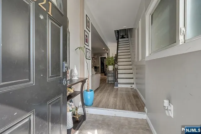 a view of entryway and hall with wooden floor