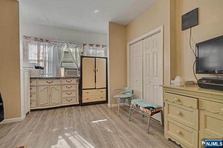 321 Grove Street Bloomfield, NJ 07017 - Photo 5 of 22 a kitchen with white cabinets and stainless steel appliances