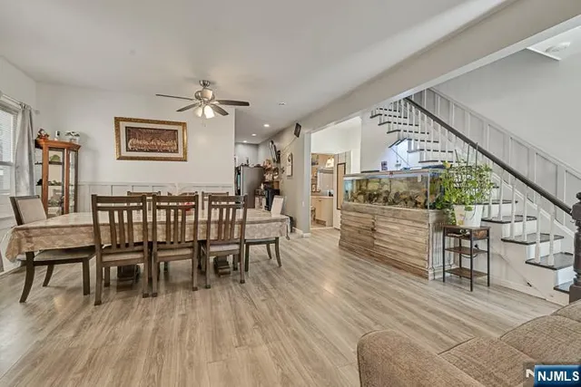 a dining room with furniture entryway and wooden floor