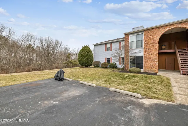 a view of an house with backyard and tree