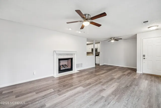 wooden floor in an empty room with a fireplace