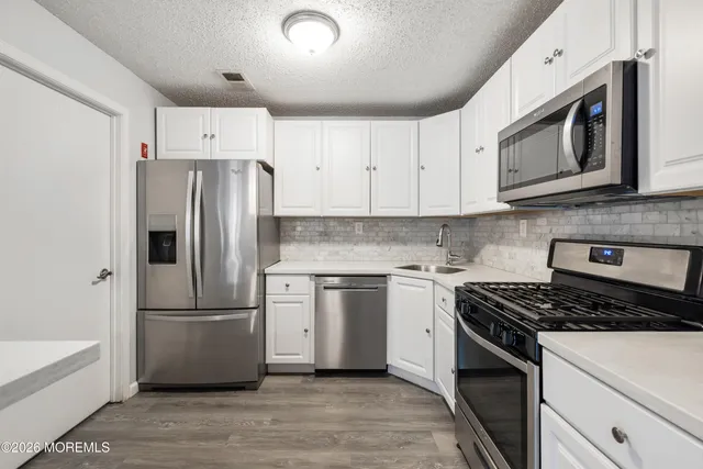 a kitchen with a refrigerator stove and microwave