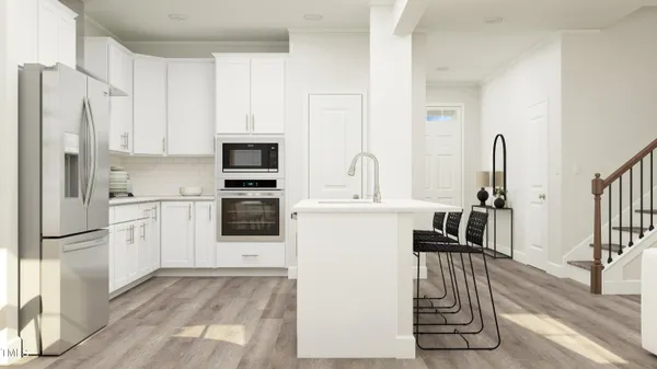 a kitchen with a refrigerator sink and white cabinets