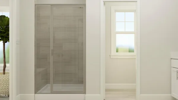 a bathroom with a glass shower door