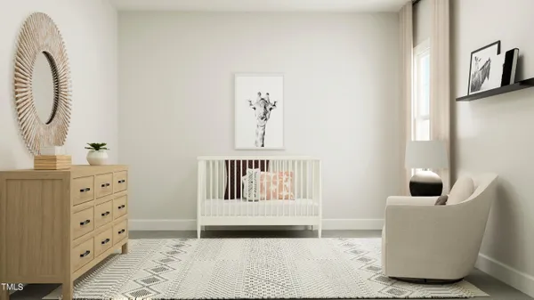 a bedroom with a baby bed and a couch