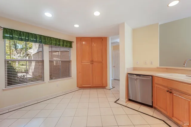 a view of an empty room with wooden floor and stairs