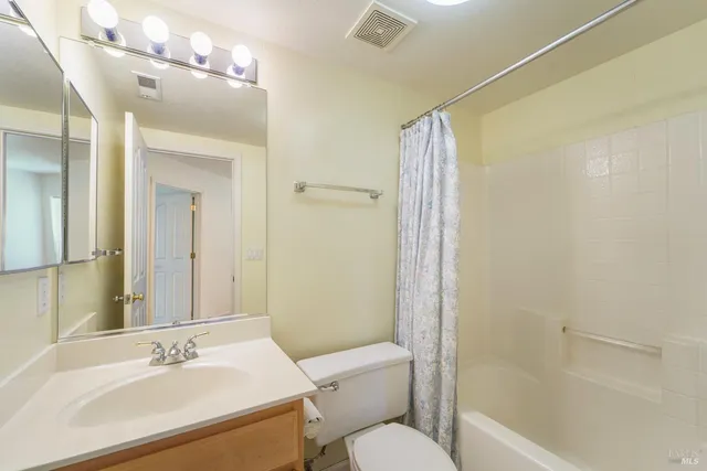 an aerial view of a house with a yard and potted plants