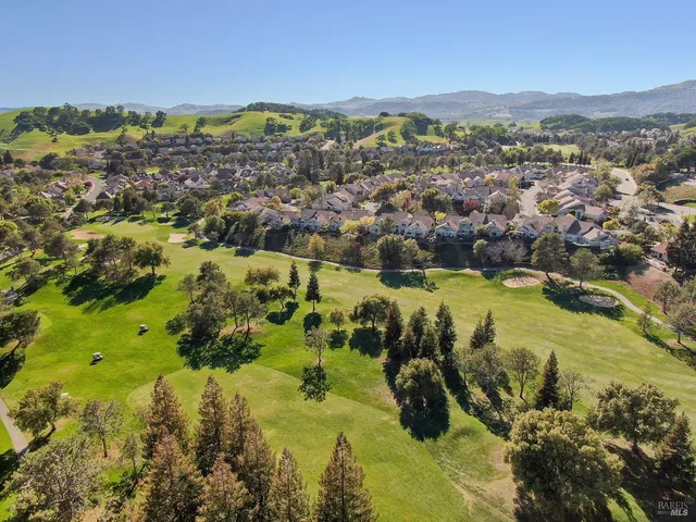 a view of a golf course with a ocean view