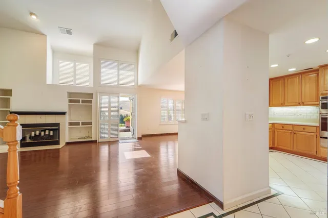 a view of a hallway with wooden floor and windows