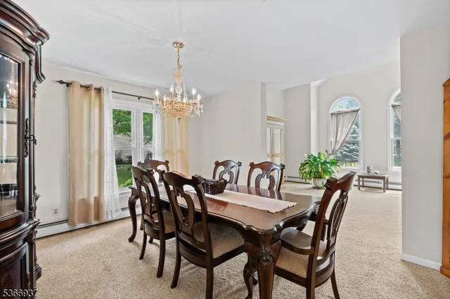 a view of a dining room with furniture and chandelier