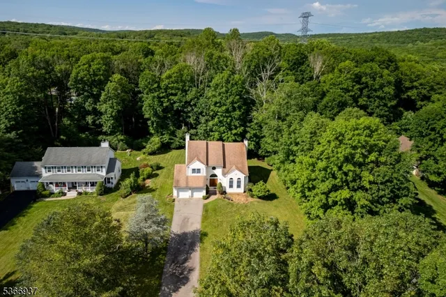an aerial view of a house with pool yard and outdoor seating