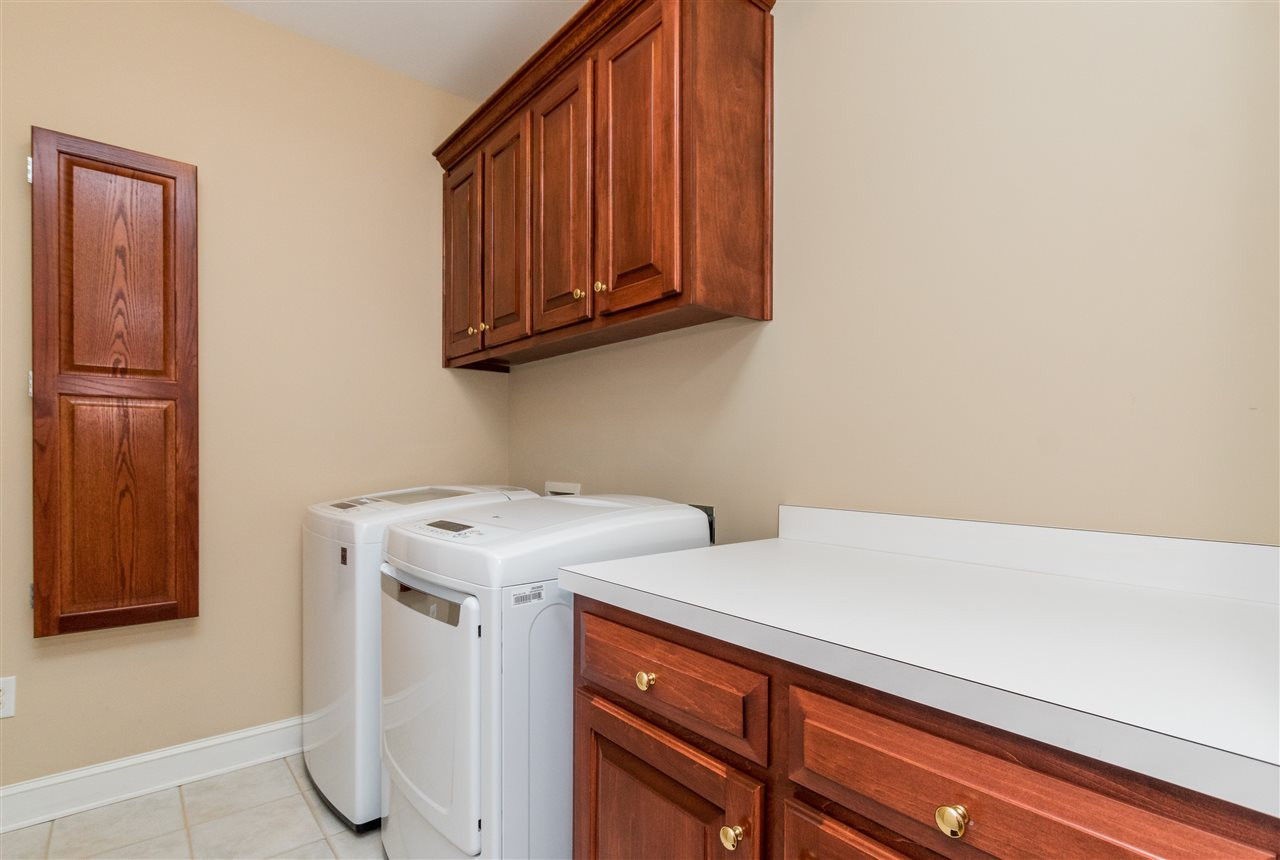107 Austin Pond Road Clayton, NC 27520 - Photo 18 of 24 Cabinets and folding area for your laundry. Laundry/utility room