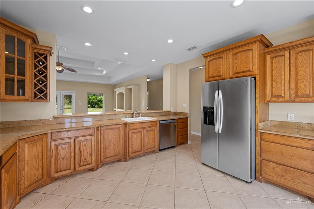 112 Madelyn Rose Bayview, TX 78566 - Photo 11 of 41 a large kitchen with stainless steel appliances granite countertop a refrigerator and a sink