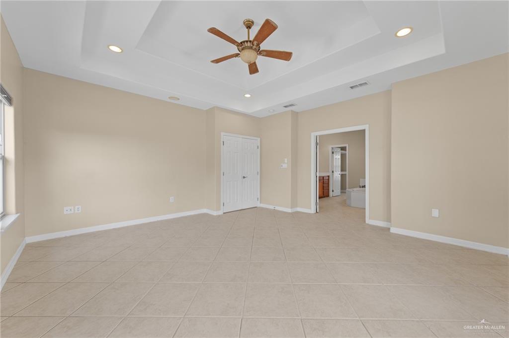 112 Madelyn Rose Bayview, TX 78566 - Photo 16 of 41 wooden floor in an empty room with a ceiling fan