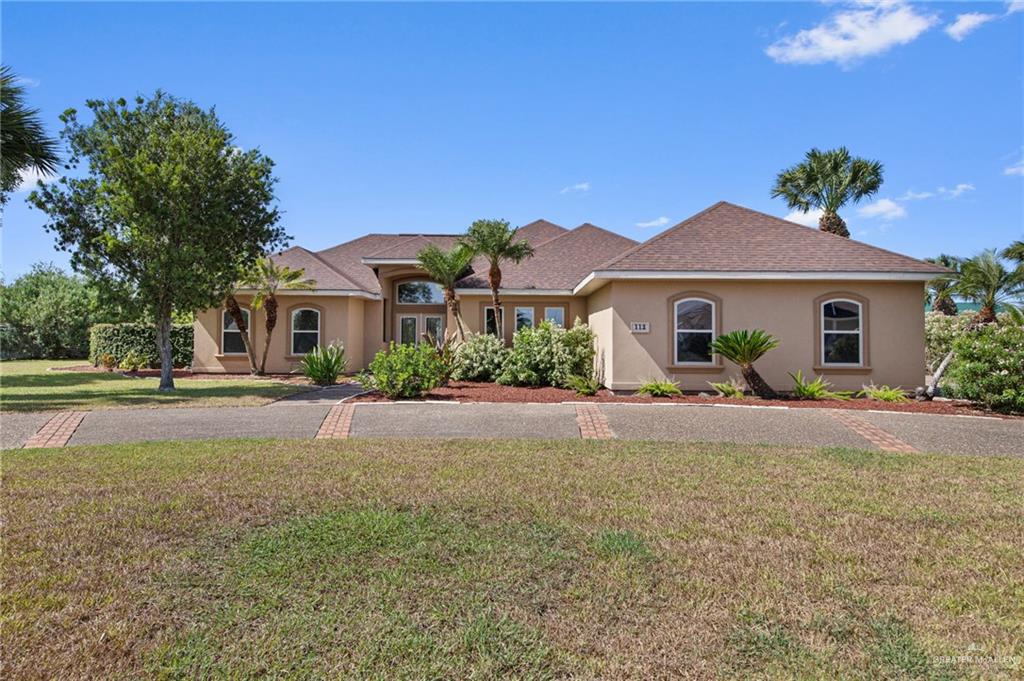 112 Madelyn Rose Bayview, TX 78566 - Photo 2 of 41 a front view of a house with a yard and garage