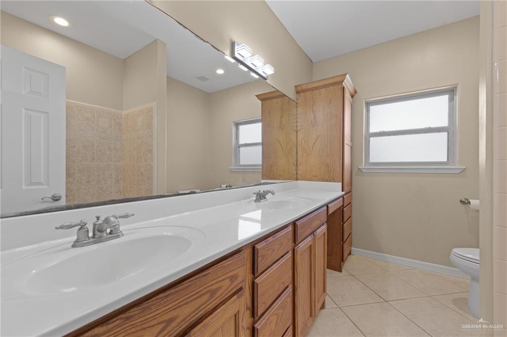 112 Madelyn Rose Bayview, TX 78566 - Photo 25 of 41 a bathroom with a granite countertop sink a mirror and a bathtub