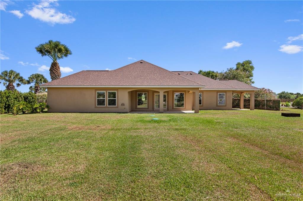 112 Madelyn Rose Bayview, TX 78566 - Photo 29 of 41 a front view of a house with a garden