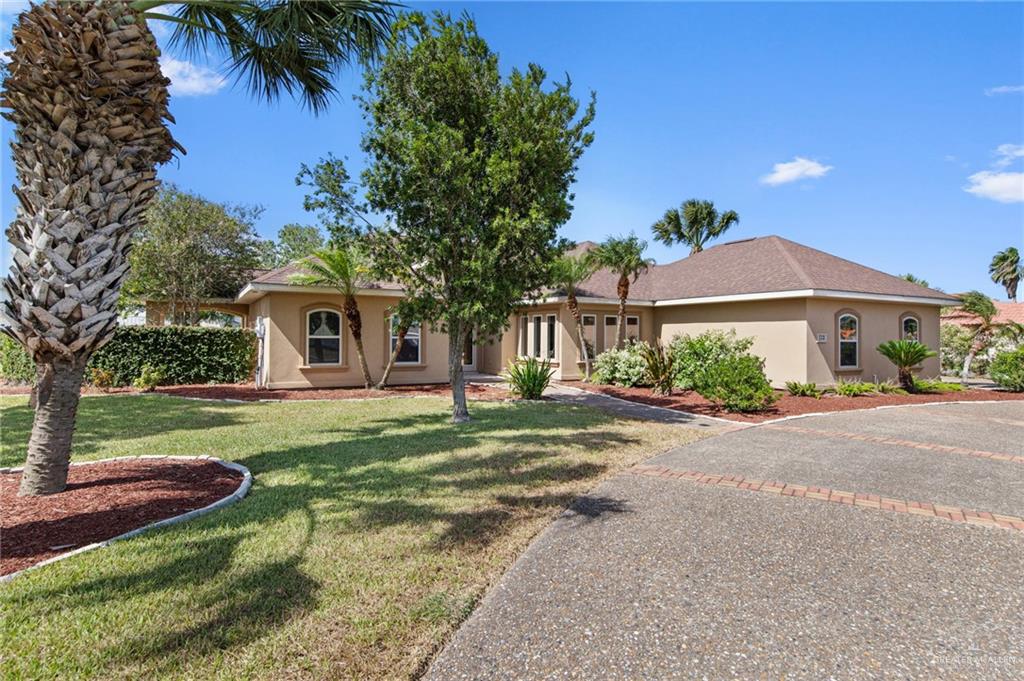 112 Madelyn Rose Bayview, TX 78566 - Photo 34 of 41 a front view of a house with a garden and yard