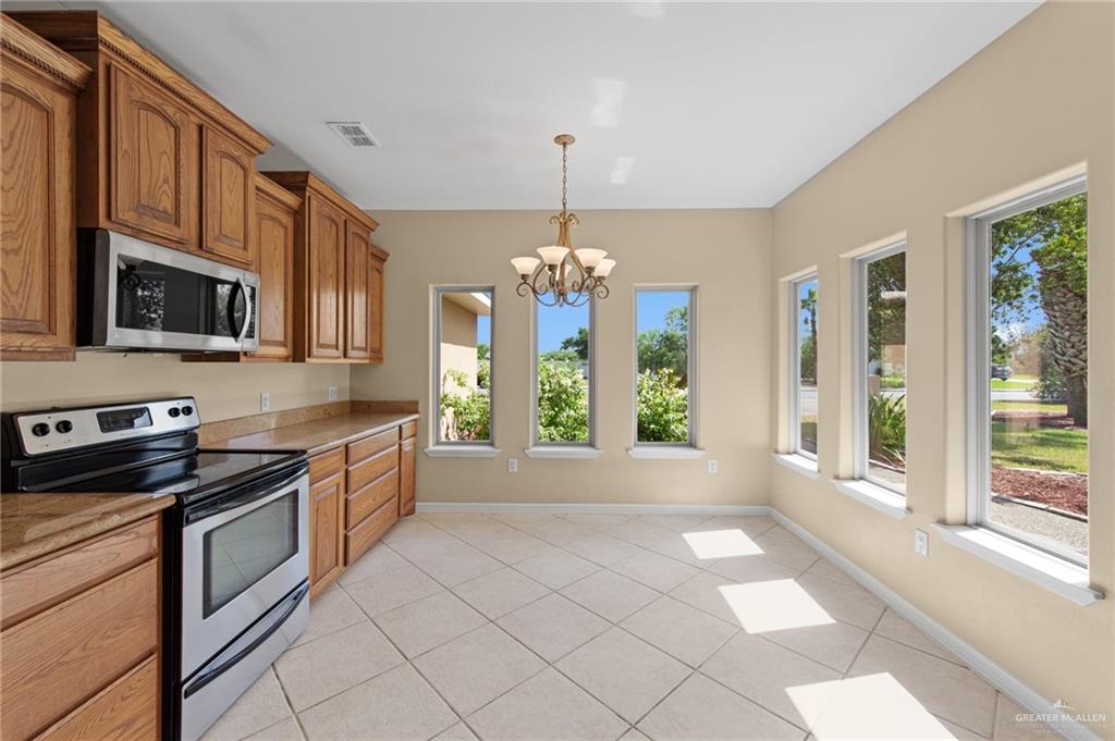 112 Madelyn Rose Bayview, TX 78566 - Photo 10 of 41 a kitchen with stainless steel appliances granite countertop a stove top oven a sink with granite countertops and cabinets
