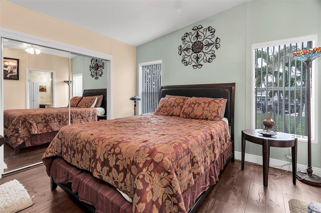 809 Putter Place Pompano Beach, FL 33069 - Photo 31 of 51 a bedroom with a bed and wooden floor